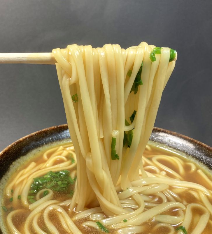 エバラ食品工業株式会社 カレーうどん 期間限定 冬のプチッとうどんのうどんを箸でつまむ