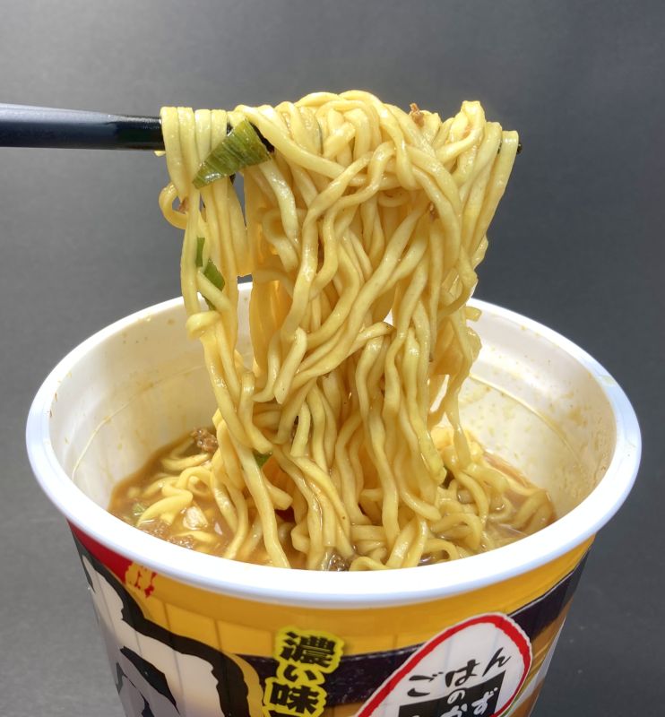 エースコック株式会社 肉カレーラーメンの麺を箸で持ち上げる